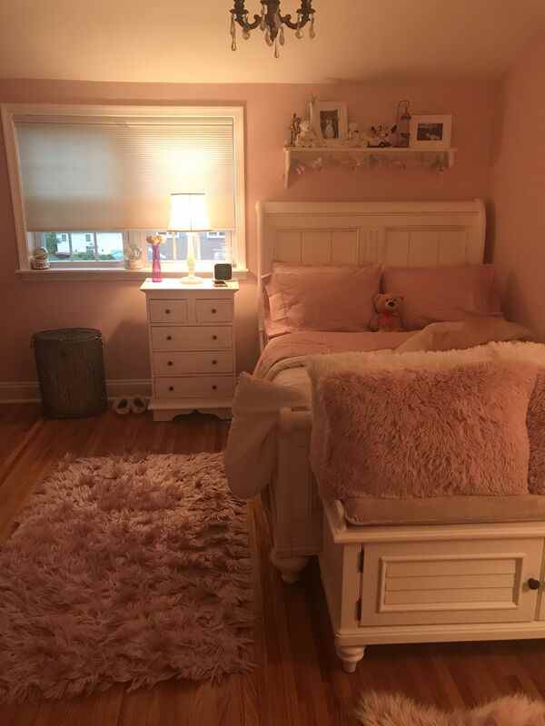 A calm bedroom scene with soft light and a neatly made bed